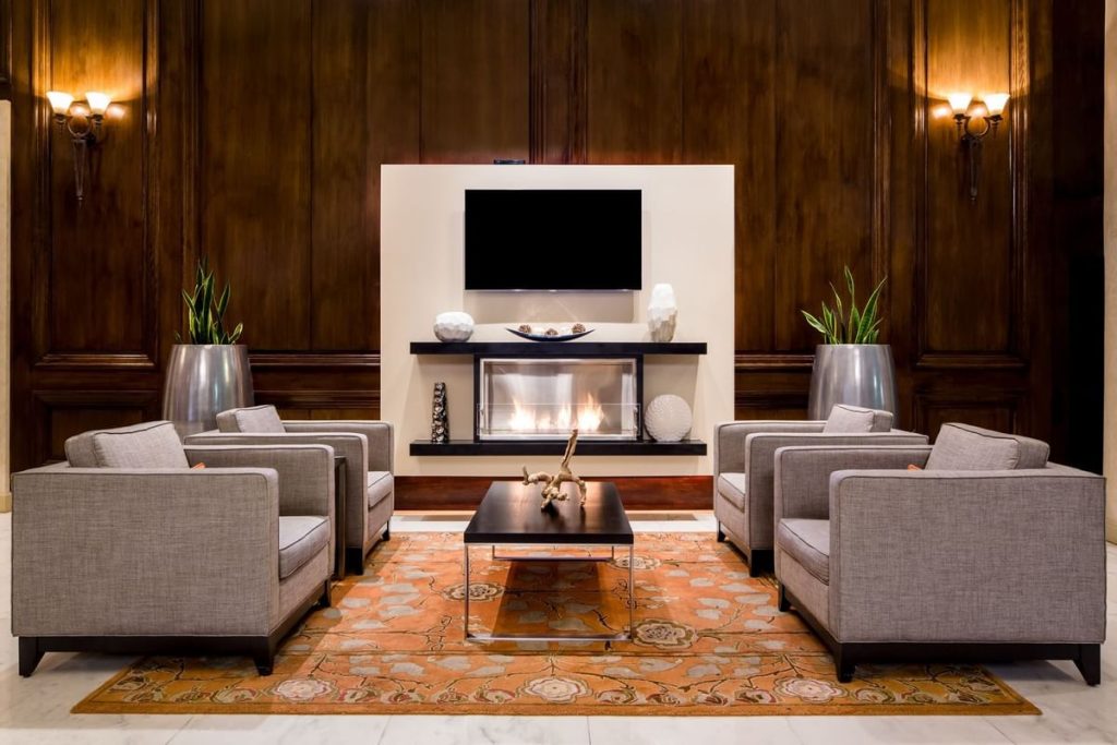The Whitehall Houston lobby lounge with fireplace and wood-paneled walls (Downtown)