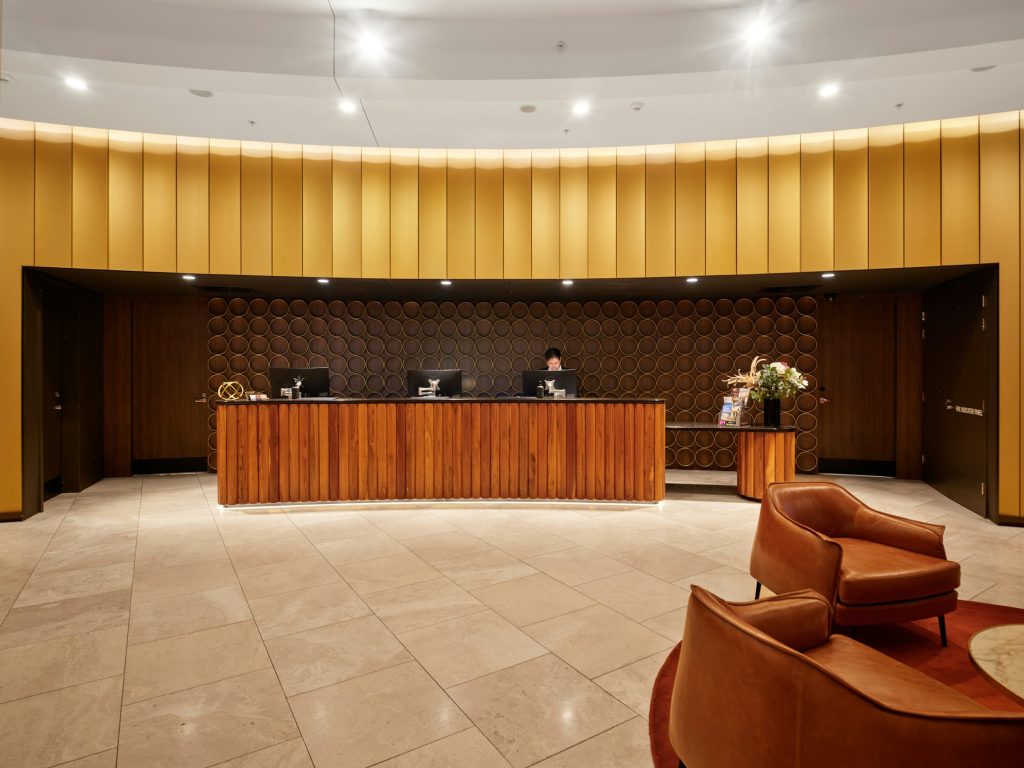 Hotel reception desk with staff member