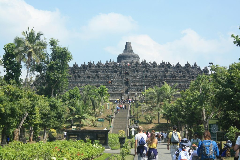 Visitors walking toward Borobudur Temple in Central Java, Indonesia