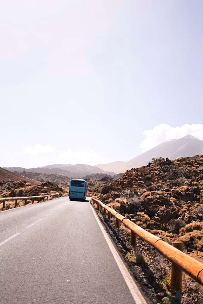 Public bus driving through volcanic landscape near Teide, Tenerife